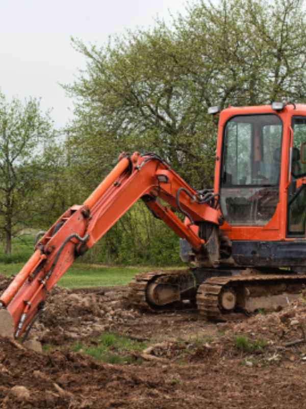 excavation services orange excavator close up
